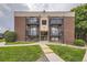 Brick apartment building featuring black iron balconies and landscaped front yard at 5995 W Hampden Ave # 2G, Denver, CO 80227
