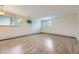 Spacious living room with wood floors, large windows, and neutral wall colors at 5995 W Hampden Ave # 2G, Denver, CO 80227