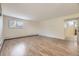 Open-concept living room with wood floors and an easy flow to the kitchen at 5995 W Hampden Ave # 2G, Denver, CO 80227