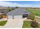 A beautiful aerial view of the property and surrounding neighborhood with a lush green lawn at 16485 E 117Th Ave, Commerce City, CO 80022