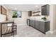 Stylish wet bar features sleek gray cabinetry, granite countertops, mini fridge, and a modern table at 16485 E 117Th Ave, Commerce City, CO 80022