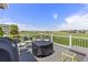Outdoor deck with grill and seating, overlooking lush green golf course at 16485 E 117Th Ave, Commerce City, CO 80022