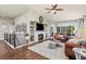 Cozy living room with hardwood floors, fireplace, and plenty of natural light at 16485 E 117Th Ave, Commerce City, CO 80022