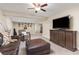 Relaxing living room boasts a plush leather sofa, comfortable seating, and a modern entertainment center at 16485 E 117Th Ave, Commerce City, CO 80022