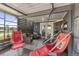 Relaxing screened-in porch with two hanging swing chairs and comfortable seating for outdoor enjoyment at 16485 E 117Th Ave, Commerce City, CO 80022
