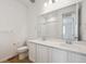 Bright bathroom featuring double vanity, quartz countertop at 230 Lark Sparrow Way, Bennett, CO 80102