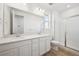 Bright bathroom featuring double vanity, quartz countertop, and glass enclosed shower at 230 Lark Sparrow Way, Bennett, CO 80102