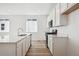 Modern kitchen with white cabinets, stainless steel appliances, and wood flooring at 230 Lark Sparrow Way, Bennett, CO 80102