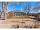 Serene backyard with a brick pathway, pergola, and beautiful landscaping under a clear sky at 1027 Norfolk St, Aurora, CO 80011