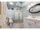 Modern bathroom with updated fixtures including a glass-enclosed shower and sleek vanity at 1027 Norfolk St, Aurora, CO 80011