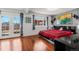 Stylish bedroom with hardwood floors, a modern bed, and French doors opening to an outdoor patio at 1027 Norfolk St, Aurora, CO 80011