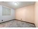A well-lit room with a window and neutral walls, featuring a clean, modern floor at 1027 Norfolk St, Aurora, CO 80011