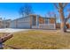 Charming single Gathering house with blue sidings, brick accents, a gray garage door, and a well-manicured lawn at 1027 Norfolk St, Aurora, CO 80011