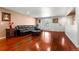 Bright living room showcasing hardwood floors, a black leather sofa, and a sunlit window at 1027 Norfolk St, Aurora, CO 80011