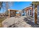 Charming backyard patio with a pergola, firepit, and French doors leading into the home at 1027 Norfolk St, Aurora, CO 80011