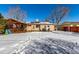 Beautiful backyard featuring stamped concrete patio, covered area, and snow-covered ground, a serene outdoor retreat at 3150 Kassler Pl, Westminster, CO 80031