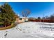 Large backyard with snow-covered lawn and playset at 3150 Kassler Pl, Westminster, CO 80031