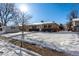 Front view of house with snowy yard and sunny day at 3150 Kassler Pl, Westminster, CO 80031