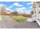 Fenced backyard with a patch of grass and a gravel area at 16108 Red Bud Loop, Parker, CO 80134
