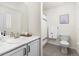 Bathroom featuring a marble countertop, a sink, a toilet, and a shower behind a curtain at 16108 Red Bud Loop, Parker, CO 80134