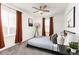 Bedroom with a ceiling fan, natural light, and gray carpet, complemented by stylish furnishings at 16108 Red Bud Loop, Parker, CO 80134