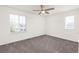 Empty bedroom featuring gray carpet, and natural light through the windows at 16108 Red Bud Loop, Parker, CO 80134