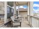 Cozy front porch featuring wicker chairs, perfect for relaxing outdoors with stone and wood accents at 16108 Red Bud Loop, Parker, CO 80134