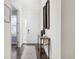 Bright hallway with stylish decor, hardwood floors, and a view of the front door at 16108 Red Bud Loop, Parker, CO 80134