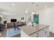 Open concept kitchen with island, eat in area, and easy access to the living room and stairway at 16108 Red Bud Loop, Parker, CO 80134