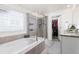 Luxurious primary bath with soaking tub, glass-enclosed shower, and a walk-in closet at 16108 Red Bud Loop, Parker, CO 80134