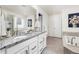 Bright primary bathroom with double vanity, granite countertop, soaking tub, and a separate shower at 16108 Red Bud Loop, Parker, CO 80134