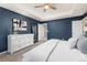 Well-lit primary bedroom showcasing a dresser, full length mirror and a doorway leading to the hallway at 16108 Red Bud Loop, Parker, CO 80134