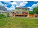 Spacious backyard with a large wooden deck, a lush lawn, and a storage shed at 2882 Signal Creek Dr, Thornton, CO 80241