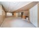 Large finished basement space featuring a wet bar and a view of additional rooms at 2882 Signal Creek Dr, Thornton, CO 80241