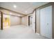 Finished basement space with neutral carpet and access to additional rooms at 2882 Signal Creek Dr, Thornton, CO 80241