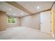 Finished basement with carpet, window and access to additional rooms at 2882 Signal Creek Dr, Thornton, CO 80241