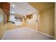 Finished basement space with carpet and a window for natural light at 2882 Signal Creek Dr, Thornton, CO 80241