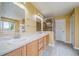 Bright bathroom features a double sink vanity, two framed mirrors, modern fixtures, and a glass enclosed shower at 2882 Signal Creek Dr, Thornton, CO 80241