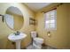 The bathroom features a stylish sink, a toilet, and a window for natural light at 2882 Signal Creek Dr, Thornton, CO 80241
