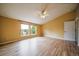 Bright bedroom features hardwood floors, a ceiling fan, and two windows that provide an abundance of natural light at 2882 Signal Creek Dr, Thornton, CO 80241