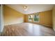 Spacious bedroom with beautiful hardwood floors, a ceiling fan, and a view of the backyard through two large windows at 2882 Signal Creek Dr, Thornton, CO 80241