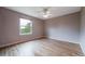 Bedroom featuring light hardwood floors and a bright window with natural light overlooking the outdoors at 2882 Signal Creek Dr, Thornton, CO 80241