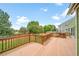 Large wooden deck with wooden railings overlooking well-maintained backyard at 2882 Signal Creek Dr, Thornton, CO 80241