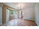 Bright dining room with bay windows, hardwood floors, and a view into the kitchen at 2882 Signal Creek Dr, Thornton, CO 80241