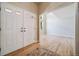 Welcoming foyer with light hardwood floors, double doors, and an open view to the living room at 2882 Signal Creek Dr, Thornton, CO 80241
