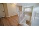 Hallway view showcases the hardwood floors, white staircase, and natural light from the two-story foyer at 2882 Signal Creek Dr, Thornton, CO 80241