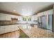 A modern kitchen boasts stainless steel appliances, granite countertops, and a unique green island at 2882 Signal Creek Dr, Thornton, CO 80241