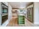 Well-appointed kitchen with white cabinetry, stainless steel appliances, and a bright green island at 2882 Signal Creek Dr, Thornton, CO 80241