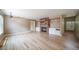 Open living room with hardwood floors, brick fireplace, built-in shelves, and ample natural light at 2882 Signal Creek Dr, Thornton, CO 80241