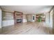Spacious living room featuring hardwood floors, a fireplace, and an open layout with the kitchen at 2882 Signal Creek Dr, Thornton, CO 80241